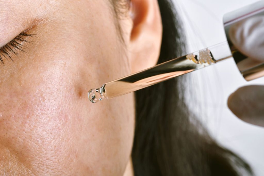 Acne or facial skin treatment, Dermatologist doctor dropping serum medicine to recover pimples skin problem. Acne or facial skin treatment, Dermatologist doctor dropping serum medicine to recover pimples skin problem.