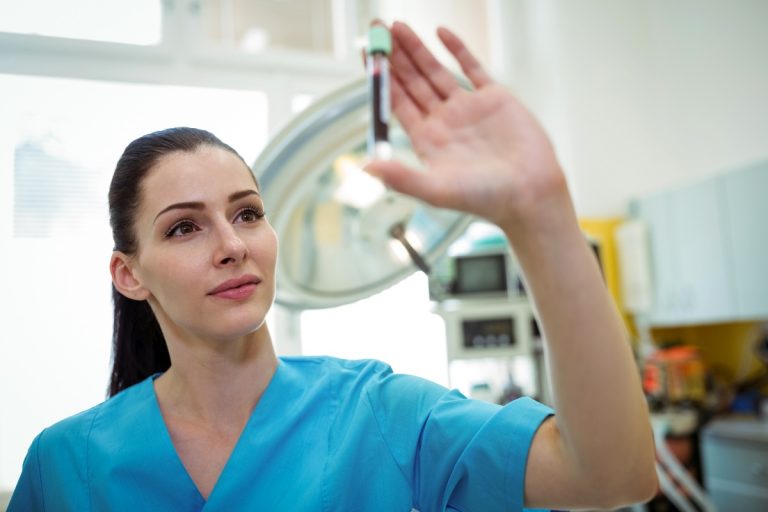 Nurse looking at the blood sample